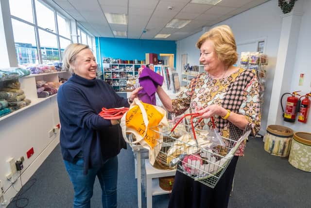 Carolyn Smith, Co-ordintor at The Cone Exchange, serving customer Christine Smith, one of the many visitors to this community scrap store.