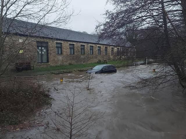 A car was stranded due to flooding after a member of the public was rescued.