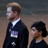 Prince Harry and Meghan, Duchess of Sussex walk as procession with the coffin of Britain's Queen Elizabeth arrives at Westminster Hall from Buckingham Palace for her lying in state. (Pic credit: Phil Noble - WPA Pool / Getty Images)