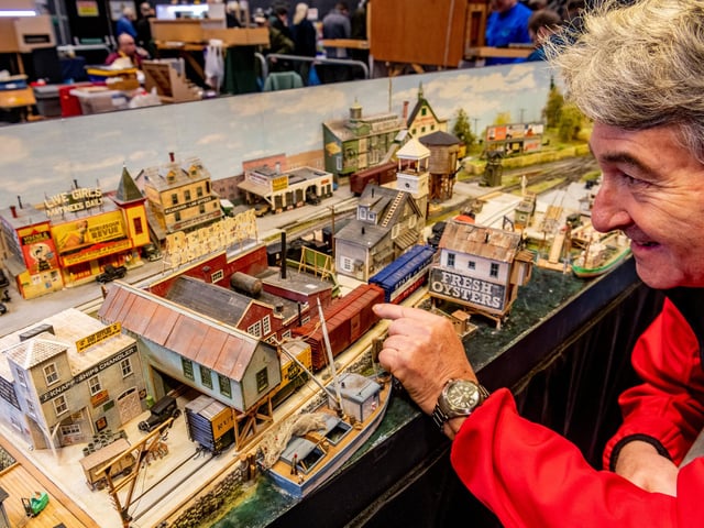 Mike Carter of Summerset, with his award winning 1940s 'Red Hook Bay' New England USA layout a fictitious busy seaport on the coast of Maine, USA. Beside the local fishing industry, Red Hook Bay is host to a brewery and a dairy. The town is a major transportation hub for the coastal islands of the coast of Maine and has ferry services from the wharf for both passengers and cars. The town is also a railroad junction for Boston & Maine and Maine Central railroads. It is also served by local tram services with a tram stop in front of Hokum's Burlesque Theatre and the Topless Bar in Main Street.