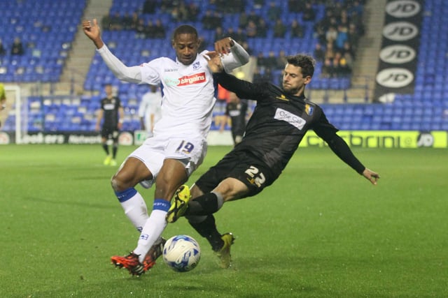Rob Taylor is tackled by Tranmere's Janoi Donacien.