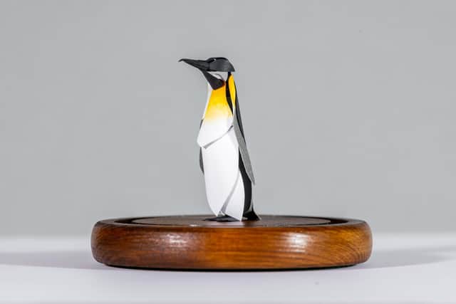 Artwork titled A Tiny Tux - Paper Cut Penguin Sculpture.