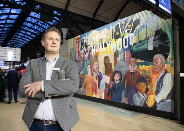 Ben Courtney, Station Manager at TransPennine Express with the new mural by local artist Andy Pea unveiled at Paragon Interchange, Hull celebrating the city's movie links at the launch of a new augmented reality version of the Hullywood trail map. Photograph by Tony Johnson.
