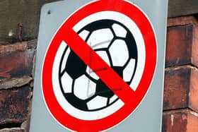 A 'No Ball Games' sign on a street.