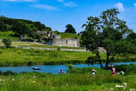 Youngsters cool off from the intense heat by pleasure boating and swimming in the River Derwent over looking ruins of Kirkham Priory. (Pic credit: James Hardisty)