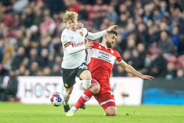 BIG BATTLE: Middlesbrough's Tommy Smith slides in on Hull City's Harry Vaughan during Wednesday night's derby clash at the Riverside Stadium.
Tony Johnson