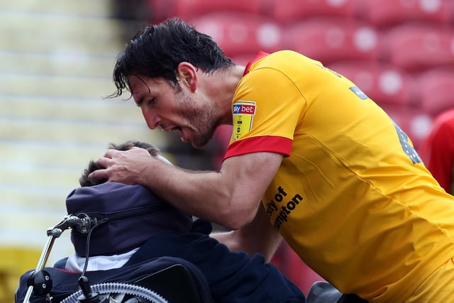 John-Joe O'Toole of Northampton Town celebrates with a disabled fan after scoring his sides goal  during the Sky Bet League Two match between Swindon Town and Northampton Town at The Energy Check County Ground on October 6, 2018.