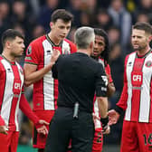 FLASHPOINT: Sheffield United players led by captain Anel Ahmedhodzic (centre) query with Darren Bond why the video assistant referee needs to look at an incident involving team-mates Jack Robinson and Vinicius Souza (not pictured)