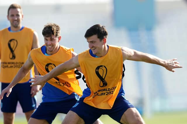 READY FOR ACTION: England's Harry Kane (left), John Stones (centre) and Harry Maguire during a training session at the Al Wakrah Sports Complex, Qatar. Picture: Martin Rickett/PA