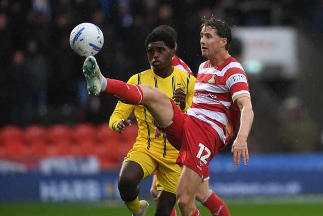 Doncaster Rovers defender Neill Byrne nips in front of Sheffield Wednesday's Jayden Heskey in last Saturday's League One derby. Picture: Jonathan Gawthorpe