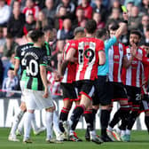 FOUL PLAY: Referee Stuart Attwell shows a yellow card to Mason Holgate of Sheffield United, which is later upgraded to a red