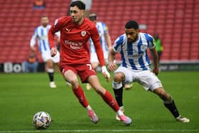 Barnsley's Corey O'Keefe gets away Huddersfield's Brodie Spencer. (Picture: Jonathan Gawthorpe)