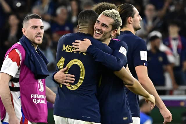 France's  Kylian Mbappe (L) celebrates with Antoine Griezmann at the end of the Qatar 2022 World Cup round of 16 football match between France and Poland (Picture: JAVIER SORIANO/AFP via Getty Images)