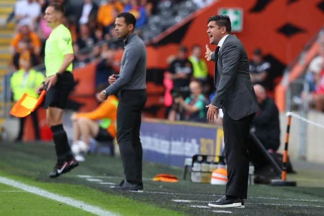 PRESSURES: Hull City's Liam Rosenior (centre) with his managerial counterpart Xisco Munoz (right), who was sacked by Sheffield Wednesday this week