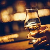 A hand holding glass of single malt Scottish whisky. PIC: PA Photo/iStock