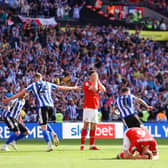TIMELY BLOW: Sheffield Wednesday's Josh Windass (No 11) turns away to celebrate after scoring his team's winning goal in the dying seconds as Barnsley's Liam Kitching and Mads Juel Andersen show their despair at Wembley Stadium. Picture: Richard Heathcote/Getty Images