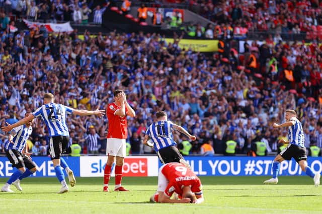 TIMELY BLOW: Sheffield Wednesday's Josh Windass (No 11) turns away to celebrate after scoring his team's winning goal in the dying seconds as Barnsley's Liam Kitching and Mads Juel Andersen show their despair at Wembley Stadium. Picture: Richard Heathcote/Getty Images