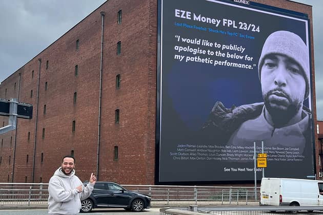Max Evans in front of a giant billboard in central Manchester with his face displayed to publicly apologise for finishing last in his friends' fantasy football manager league.Max Evans/PA Wire