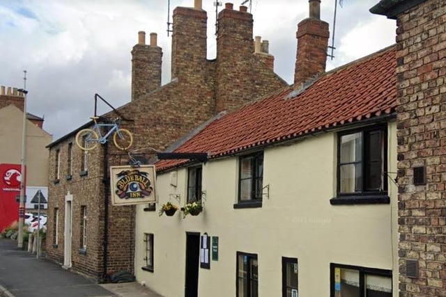 The CAMRA experts wrote in the guide: "This Grade II-listed establishment dating from the 16th century is recognised by CAMRA as having a historic interior of regional importance. It was named the Blue Ball in 1823. The low front elevation hides a maze-like interior, with the frontward cosy bar, compact servery and linking corridor retaining most of the historical flavour. A smoking area is at the rear. Home-cooked food is served daily (except Wed)."