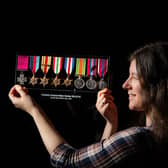 Head of Collections, Zoe Utley at The Green Howards Museum in Richmond with medals awarded to CSM Stanley Hollis including his Victoria Cross, photographed by Tony Johnson for The Yorkshire Post. A new  exhibition at the museum commemorates the 2000 Green Howards who landed in Normandy on 6th June 1944.