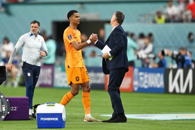DOHA, QATAR - DECEMBER 03: Cody Gakpo of Netherlands shakes hands with Louis van Gaal, Head Coach of Netherlands, after being substituted during the FIFA World Cup Qatar 2022 Round of 16 match between Netherlands and USA at Khalifa International Stadium on December 03, 2022 in Doha, Qatar. (Photo by Dan Mullan/Getty Images)