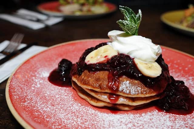 Tripled-stacked Buttermilk Pancakes with Berry Compote, Banana and Yoghurt. Pic credit: Marie Caley)