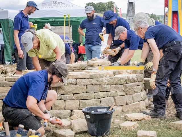 Chatsworth Country Fair 2025 - Volunteers from Derbyshire Dry Stone Walling Association creating an 'S' shaped wall witg seating for this year's show that wil remain in place until next year.
