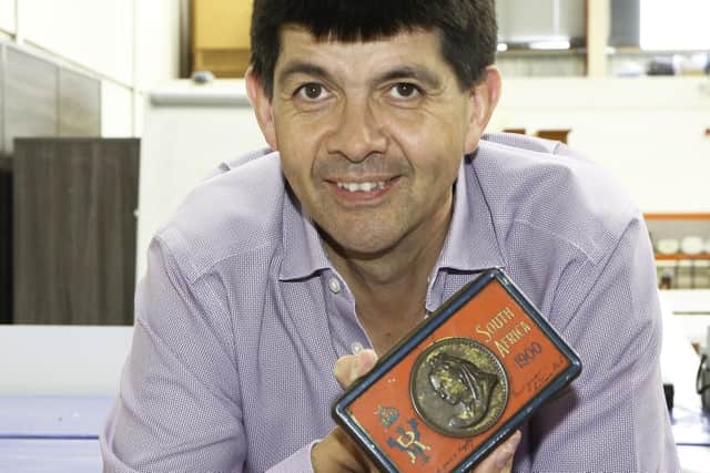 Auctioneer Paul Cooper with the Boer War chocolate tin. See SWNS story SWMRchocolate; See SWNS story SWMRchocolate; A box of 122-year-old chocolate bars, that were sent to troops fighting in the Boer War, has been discovered in an attic.