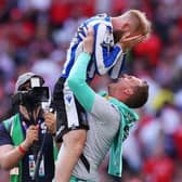 Sheffield Wednesday captain Barry Bannan celebrates promotion at Wembley on Monday with David Stockdale. Picture: Richard Heathcote/Getty Images.