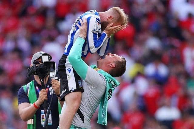 Sheffield Wednesday captain Barry Bannan celebrates promotion at Wembley on Monday with David Stockdale. Picture: Richard Heathcote/Getty Images.