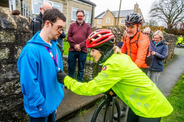 Mollie King chatting with one of the residents of Stutton near Tadcaster, North Yorkshire, Will Browning, who won a Gold Medal at the Special Olympics World Games held in Berlin 2023, during her stop-off before heading onto finishing line in Hull.