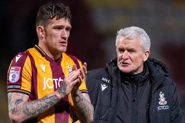 Mark Hughes has some words of wisdom for Andy Cook. (Picture: Bruce Rollinson)
