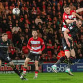 KEY MOMENT: Owen Bailey heads in Doncaster Rovers' winning goal against Wrexham at the Eco Power Stadium on Tuesday night. Picture: Bruce Rollinson