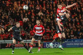 KEY MOMENT: Owen Bailey heads in Doncaster Rovers' winning goal against Wrexham at the Eco Power Stadium on Tuesday night. Picture: Bruce Rollinson