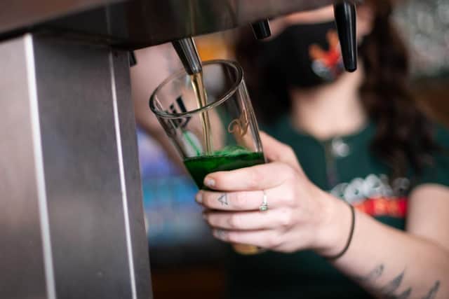 A bartender pours a pint of green beer on St. Patrick's Day. (Pic credit: Mark Makela / Getty Images)