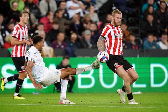 Swansea City's Ben Cabango has a shot blocked by Sheffield United's Oliver McBurnie during the Sky Bet Championship match at the Swansea.com Stadium, Swansea.  Picture: David Davies/PA Wire.