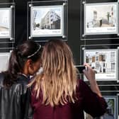 A couple of women studying the house price signs in an estate agents window. PIC: Yui Mok/PA Wire