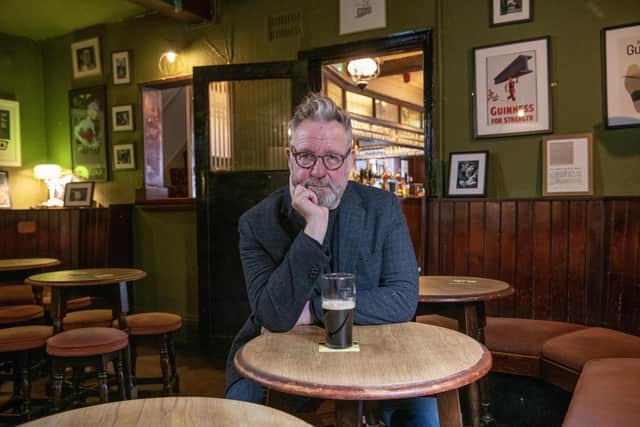 Sheffield artist Pete McKee in Fagans pub where he painted his famous mural The Snog which is the subject of a new exhibition, photographed for the Yorkshire Post Magazine by Tony Johnson.