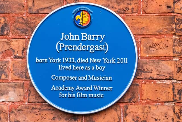 A blue plaque in memory of composer and musician John Barry on the wall of the York Pavilion Hotel, Main Street, Fulford, York. Picture By Yorkshire Post Photographer,  James Hardisty.