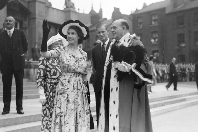The then Princess Elizabeth waves to the crowd at Leeds Civic Hall in 1949. The report at the time noted: “She was wearing a floral silk tea dress in an intriguing, if indecipherable print (which, judging by the lady behind her, was all the rage that year).”