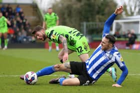 Tangled up: Sheffield Wednesday's Lee Gregory, right, and Forest Green Rovers' goalscorer Jordon Garrick challenge for the ball (Picture: Nigel French/PA Wire)