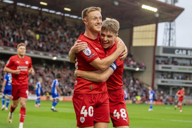 Barnsley's Davis Keillor-Dunn and Reds captain Luca Connell. Photo: Tony Johnson.