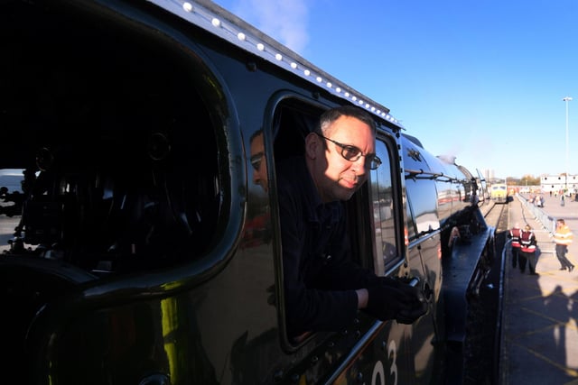 Crowds welcome back the Flying Scotsman back to Doncaster,  Freightliner Railport, Decoy Bank South, Doncaster. Fraser Birrell the fireman on the engine looks of the window Picture taken by Yorkshire Post Photographer Simon Hulme