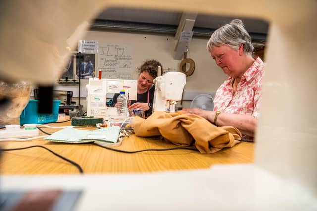 Staff and volunters preparing costumes at the York Theatre Royal Wardrobe Department in York  for the new tudor production Sovereign. Pictured Chloe Moore, Senior Wardrobe Technician, working alongside volunteer Catherine Sotheran.