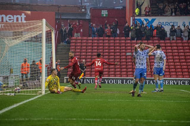 Lewis celebrates his late equalising goal for Reds. Photo: Tony Johnson.