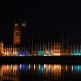 The Houses of Parliament is lit up in blue to mark the 75th anniversary of the NHS. PIC: Lucy North/PA Wire
