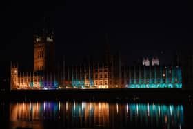 The Houses of Parliament is lit up in blue to mark the 75th anniversary of the NHS. PIC: Lucy North/PA Wire