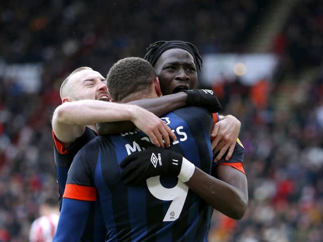 Luton Town's Carlton Morris (centre) celebrates with team-mate Elijah Adebayo after scoring their side's winning goal against Sheffield United (Picture: PA)