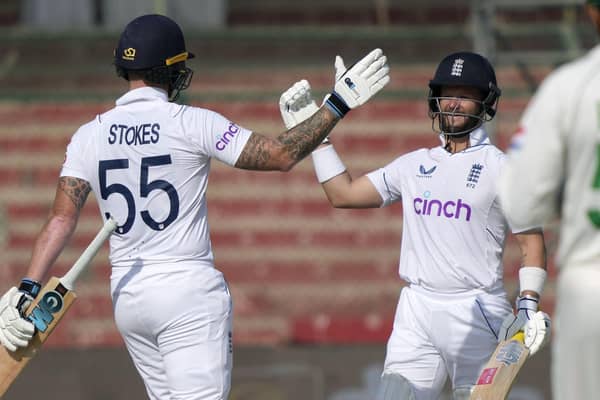 HISTORY BOYS: England's Ben Duckett, right, celebrates with captain Ben Stokes after winning the third test cricket match against Pakistan, in Karachi Picture: AP Photo/Fareed Khan