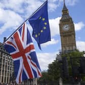 An EU and a Union Flag are seen in front of Elizabeth Tower (Big Ben) during a pro-EU rally in 2017. PIC: NIKLAS HALLE'N/AFP via Getty Images